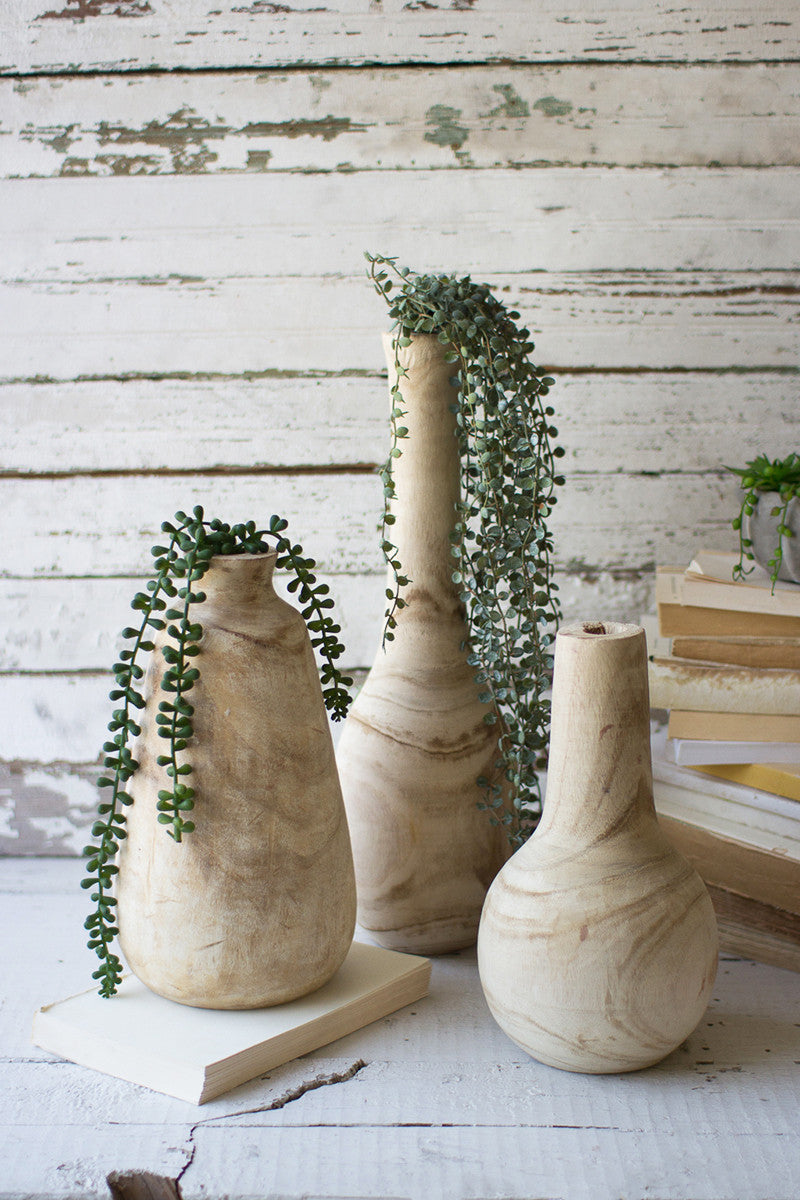 SET OF THREE HAND-CARVED TALL WOODEN BOTTLES
