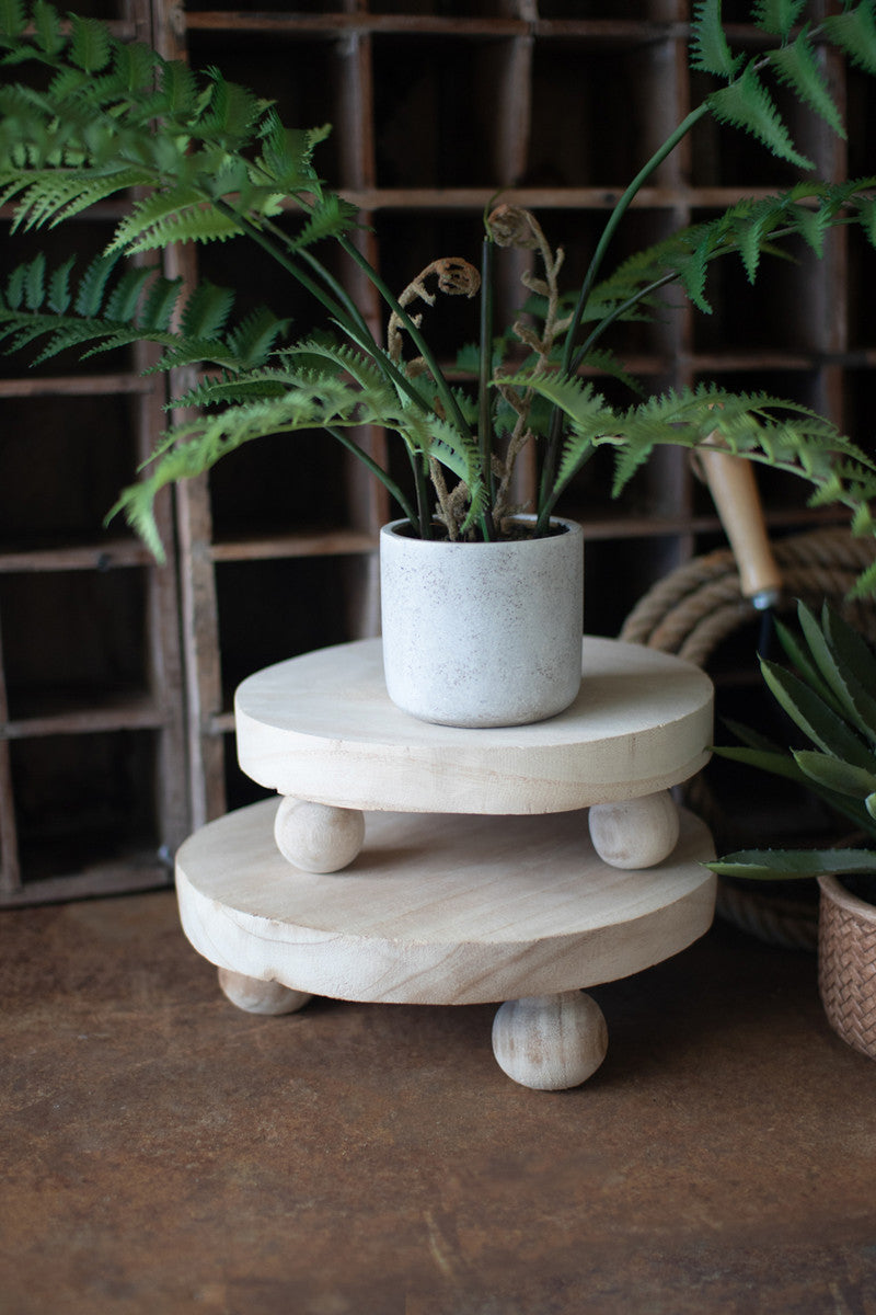 SET OF TWO ROUND WOODEN RISERS WITH BALL FEET