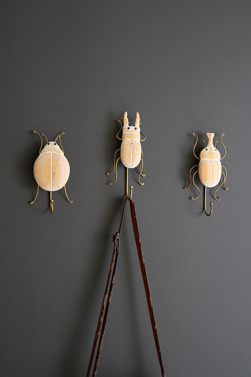 SET OF THREE CARVED WOOD AND WIRE BEETLE WALL HOOKS